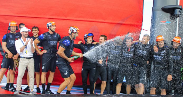 AC201219sg_11023 36th America’s Cup presented by Prada Race Day 3 Mike Lee sprays champagne as Emirates Team New Zealand celebrate their America’s Cup World Series win